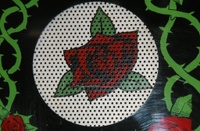 Image # 33087: Guns N' Roses Sample Game - Speaker Grill 
(On production games, the background is black, not gray. Game has serial number 110878 manufactured May 23, 1994.)