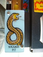 Image # 33415: Guns N' Roses Snake Pit Plastic 
(Note the bulb with yellow cover protruding from under the top of the plastic.)