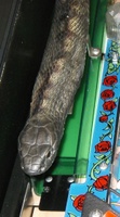 Image # 33093: Guns N' Roses Sample Game - Snake 
(Snake is solid flexible rubber, screwed onto a plate. On production games, snakes are molded thin plastic, much greener and shinier, have a different look, and have their tails. Game has serial number 110878 manufactured May 23, 1994.)