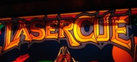 Image # 44346: Laser Cue Illuminated Defective Backglass - Detail 
(Words that should appear in the lit red areas at the bottom of the glass were mistakenly screened at the top of the glass, obscuring the game name. From the game with serial number 520 09500.)