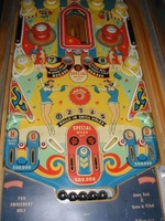 Image # 44168: Lulu Playfield 
(The '1' insert above the left flipper is not original to this game. The paper apron at playfield bottom is a reproduction.)