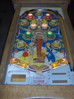 Image # 46187: Mademoiselle Illuminated Playfield 
(The white bumper caps on this game have had their existing stampings re-inked by the game owner with a red color, as suggested in the black-and-white flyer.)