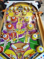 Image # 67419: Majorettes Sample Game - Playfield 
(The four orange clamps shown here are part of a makeshift playfield rotisserie. The owner added a red flipper rubber to the black upper arch rebound rubber. Serial number 01006 S.)