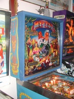 Image # 10506: Mystic Early Production Backglass 
(In this early backglass version, the center eye is recessed into the backbox and, when lit, creates a 3-D effect. This image is from the game with serial number EMY1060 (shown in the upper left of the backbox), the 60th game produced. The center drop targets have the wrong design for this game.)