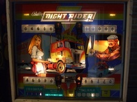 Image # 50352: Night Rider 100,000 Point Thresholds 
(Relays are used to record for each player when 100,000 points are scored. Here, all four player scores are lit in this way. Also, the glass shows that 'Same Player Shoots Again' is lit.)