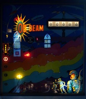 Image # 46812: On Beam Later Production Illuminated Backglass 
(This game was photographed in an old church, thus two stained-glass windows are reflected in the backglass. Serial number 2178.)