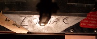 Image # 42242: Planets Inside Front Door - Detail 
(The coin return funnel is marked 'Zodiac'. Serial number 99486. Elsewhere on this game is serial number 99584.)
