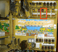 Image # 83194: Race-Way Inside Two Tilt Backbox - Annotated 
(The red rectangle identifies the location of the Tilt Relay. The white square identifies the location of the two Game Over Relays. The dual outlet box is an after-factory modification and the fuse block below it is a replacement. The scenic artwork and white relay strips are reproduction.)