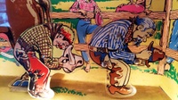 Image # 69240: Rancho Animation Comparison 
(The metal cowboy from a 'Cow Poke' game has been placed in this image to compare it to the plastic cowboy in the 'Rancho' game.)