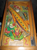 Image # 52398: Rocket Playfield 
(The triangular post between the flippers is not original, and would be round. The red flipper above this post is not original and we do not know if it operates. The posts in the lower left and right corners of the playfield have been moved from their original positions.)