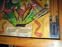 Image # 52403: Rocket Lower Playfield 
(The triangular post between the flippers is not original, and would be round. The red flipper above this post is not original and we do not know if it operates. The posts in the lower left and right corners of the playfield have been moved from their original positions.)