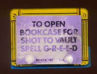 Image # 59868: The Addams Family Early Production Game Bookcase Plastic with Sticker 
(A sticker with new instructions has been applied to the plastic until new plastics with this printing arrived at the production line.)