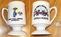 Image # 82047: The Addams Family Promotional Mug 
(Designer Pat Lawlor had these mugs made after the game broke the sales record and they were distributed to every employee at the company. A 500 Lire coin is included here to help indicate size. 500 Lire was also the price of 1 Play in Italy at the time of this game.)