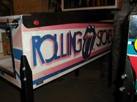 Image # 16333: Rolling Stones Early Production Cabinet - Right 
(This is from the game with serial number 1013, the 13th game produced. The metal plate located near the leg reads 'PROP. NO. 14861'.)