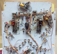Image # 69132: Safari Under Lower Playfield 
(The factory passive bumper between the flippers, which would appear under the playfield as a simple switch, has been replaced here by a pop bumper coil assembly. Near the left flipper coil is an unidentified relay not present on other games. Serial number 1354.)