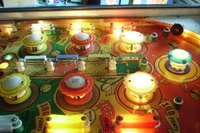 Image # 45306: Show Boat Illuminated Upper Playfield 
(On this playfield, each of the two pairs of blue posts at the top of the playfield should have a white rubber ring stretched between them.)