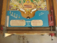 Image # 48761: Sluggin' Champ 'Deluxe' Lower Playfield 
(All plastic parts on this playfield are reproduction, as is the blue tray liner, but we show this image to present the playfield art and cabinet design.)