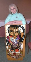 Image # 53371: Sorcerer Artist and Playfield 
(Artist Pam Erickson at Chicago Pinball Expo 2004.)