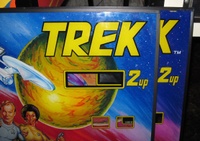 Image # 52948: Star Trek Backglass Comparison - Detail 
(The glass on the left lacks a trademark symbol after the name and no adhesive 'Credit' sticker was applied to the credit window.)