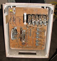 Image # 43120: Straight Flush Inside Backbox 
(The wooden chime box in the upper left corner is missing its coil and solenoid, although the metal chassis remains. The two 1,000,000 point lamps in the upper right corner have their ground wire dangling, unconnected, because it used to be attached to the ground wiring above the hundreds reel until two lamp sockets for two score reels were removed. In the lower half of the insert, one of the two cable connectors has been removed.)
