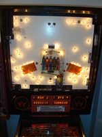 Image # 39440: Big Guns Behind Backglass - Bagatelle Flash Lamps 
(The hole and its two flash lamps at the bottom of the bagatelle were removed from later games. Serial number 557 118502. Date of manufacture was faded but the playfield is stamped with an Oct 30/87 date.)