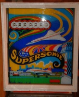 Image # 55882: Supersonic Alternate Backglass - No Lines 
(The wings of the flying Concorde lack the blue and gold lines found on other backglasses. The tower wall lacks the artful lines to indicate individual bricks. Serial number 00120.)