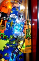 Image # 77454: Al's Garage Band Goes On a World Tour Early Production Playfield - Top Ball Lock VUK 
(Seen here at the end of the horseshoe ramp, this VUK was removed early in production. Serial number not given.)