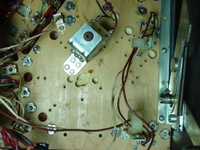 Image # 29708: Junk Yard Prototype Playfield Underside 
(Picture shows holes routed in the prototype playfield for what could be a pop bumper, sling kicker, and scoring switches in the upper right hand corner of the playfield.)