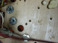 Image # 29710: Junk Yard Prototype Playfield Underside 
(Picture shows holes in a prototype playfield for scoring switches in the upper right hand corner of the playfield.)