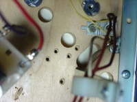Image # 29712: Junk Yard Prototype Playfield Underside 
(Picture shows holes in a prototype playfield in the upper right hand corner of the playfield.)