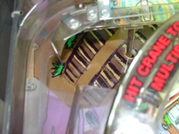 Image # 29765: Junk Yard Prototype Playfield Change Detail 
(This photograph shows a playfield decal covering the holes from where prototype features were removed.)