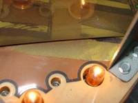 Image # 29767: Junk Yard Prototype Playfield Change Detail 
(This photograph shows a playfield decal covering the holes from where prototype features were removed.)