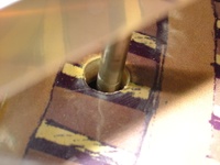 Image # 29768: Junk Yard Prototype Playfield Change Detail 
(This photograph shows a playfield decal covering the holes from where prototype features were removed.)
