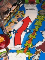 Image # 38311: South Park Early Production Playfield with Decal 
(For illustrative purposes, the arrow decal and its opaque backing were temporarily affixed to the playfield using adhesive tape. Game has serial number 146406.)