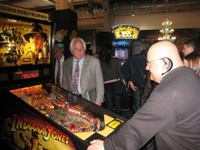 Image # 42322: Indiana Jones Sample Game - Test Location in Italy 
(Gary Stern is watching Federico Croci play at a Show doubling as a test location in Rimini, Italy in March 2008. Backbox topper reads 'preliminary graphics and game rules'. Serial number E 216297. After the show, the game was shipped back to Stern in the USA.)
