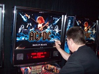 Image # 52340: AC/DC Back In Black (Limited Edition) Signed Backglass 
(Designer Steve Ritchie is signing a backglass at the 2012 Texas Pinball Festival.)