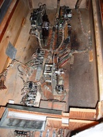 Image # 64297: Cover Girl Inside Cabinet 
(The relay mounted to the cabinet wall is not original to this game. It replaced the original relay and is mounted on the wall because it does not fit in its original place on the motor board where a bare stretch of metal bar is now seen. The square piece of sheet metal stapled to the left wall is not original and was placed temporarily during cabinet repair.)
