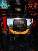 Image # 57427: The Wizard of Oz (Standard Edition) Test Game on Location 
(The red ticket vendor box is attached to the Tron machine. Photographed at the March 2013 ENADA coin-op trade show in Rimini, Italy.)