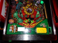 Image # 57425: The Wizard of Oz (Standard Edition) Test Game on Location 
(The red ticket vendor box in the left is attached to the Tron machine. Photographed at the March 2013 ENADA coin-op trade show in Rimini, Italy.)