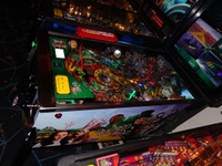 Image # 57426: The Wizard of Oz (Standard Edition) Test Game on Location 
(The red ticket vendor box is attached to the Tron machine. Photographed at the March 2013 ENADA coin-op trade show in Rimini, Italy.)