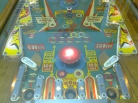 Image # 56437: Cue Ball Lower Playfield 
(The white target and the blue and green pop bumper platters are not original to this game. The top gobble hole has been painted blue.)