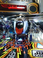 Image # 66376: KISS (Pro) German Playfield - Spinning Disc 
(An illuminated insert points to the spinning disc below the Demon head.)