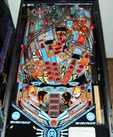 Image # 6684: Demolition Man Playfield - Unlabeled Inserts 
(The three round orange inserts on the left side of the playfield are not labeled with point values. )