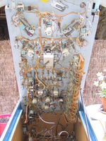 Image # 48476: Doodle Bug Under Early Production Playfield 
(The after-factory wiring for the yellow rollover button is evident in this picture. The knocker and large bell at rear of cabinet were added by a game owner. Serial number 65420.)