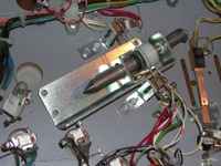 Image # 58800: Eight Ball Deluxe Prototype Game - Under Playfield - Detail 
(Slingshot kicker mechanism with coil removed to see the tapered plunger. Serial number EED9201.)