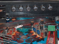 Image # 54049: F-14 Tomcat Early Production - Flash Lamp Insulators 
(Serial number 554 95836. The green spinning target has little relative wear for the age of this game and is deemed a replacement. The red target on the right likely replaced an original blue one. A 2-inch white rubber ring probably should replace the two smaller rubber rings shown here between the standup targets, to encircle all three posts.)