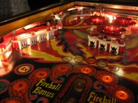 Image # 40267: Fireball II Illuminated Upper Left Playfield 
(The factory mylar has been removed from this playfield. The drop targets and bumper caps are after-factory manufacture using Bally's original dies.)