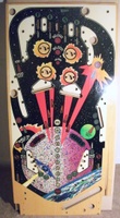 Image # 70299: Firepower 1982 Playfield - Front 
(This playfield is clear coated and was described to us as New Old Stock. The huge round spaceship in the lower playfield has a red hue, not a blue hue as found in first-production playfields.)