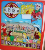 Image # 37592: Flipper Cowboy Backglass 
(An after-factory replay unit has been added to this game, photographed at the 2006 Vierzon Pinball Show in France. We retain this image to show the other features of this backglass.)