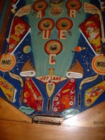 Image # 58735: Flying Saucers Lower Playfield 
(The white pop bumper cap printed with 'VENUS' is missing at the top of this picture. The words 'Tilt Reset' are inexplicably missing from the playfield directly below the red post between the flippers.)